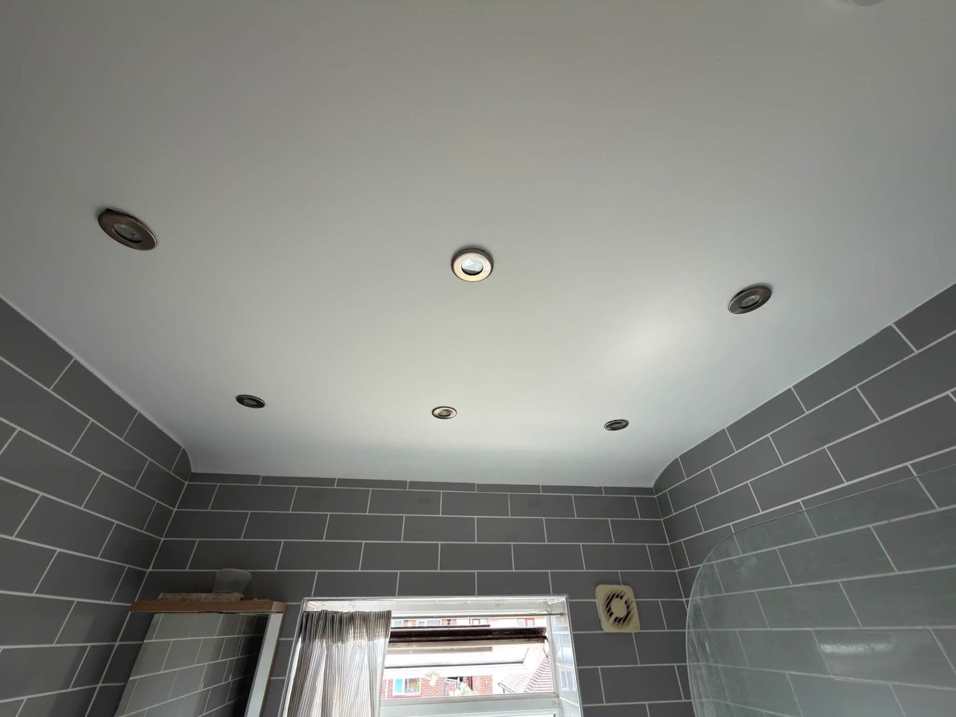 The same bathroom ceiling after preparation and a flawless new finish